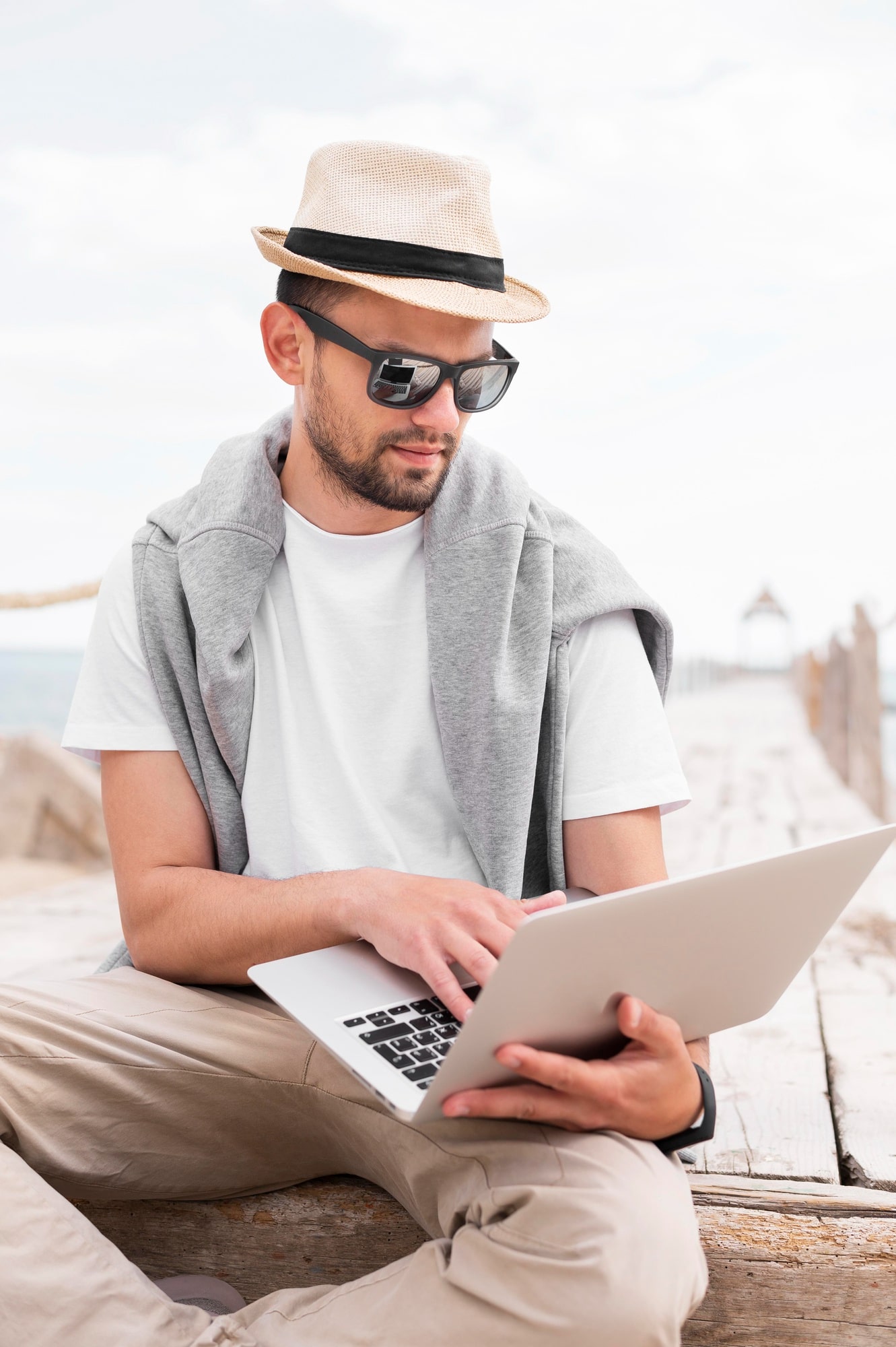 man-working-laptop-beach-min